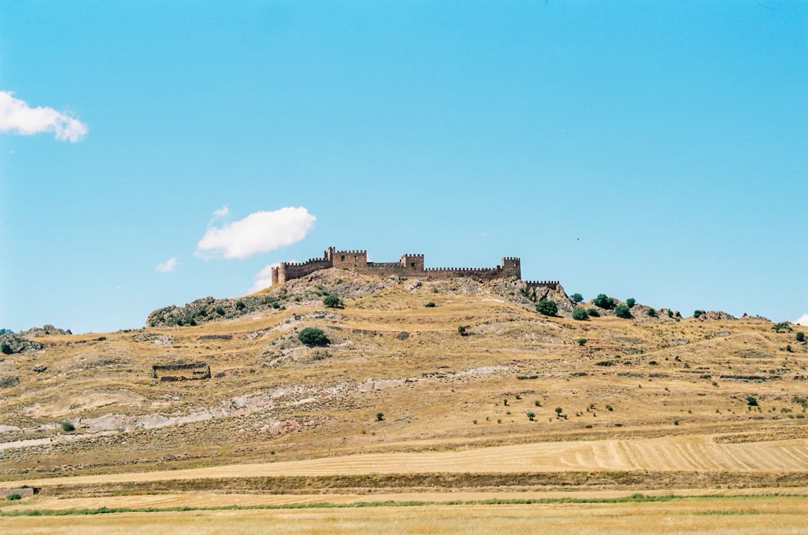 Example: a castle on a dry hill under a blue summer sky
